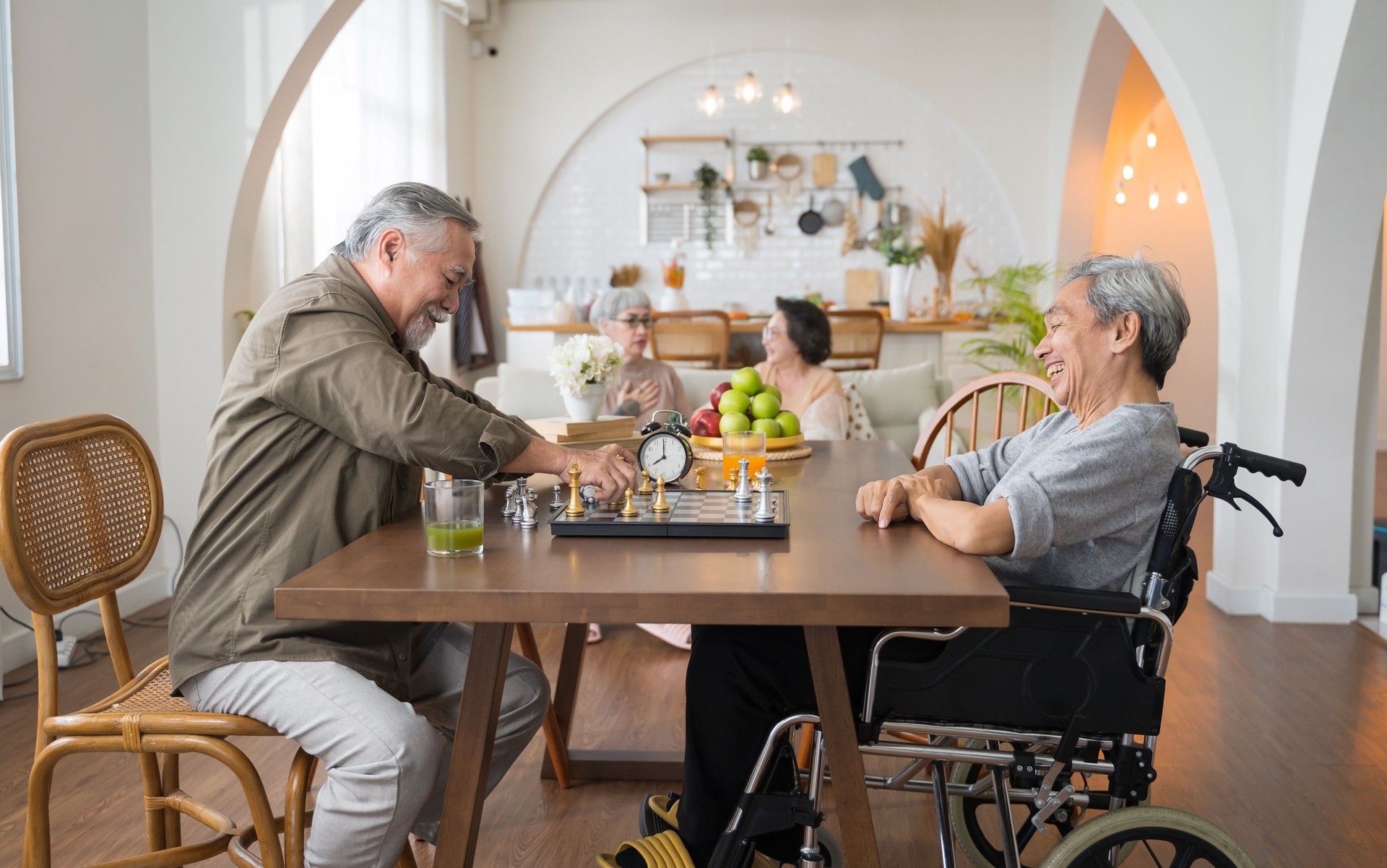 Portrait of two Asian senior men playing chess and in nursing home at Azalea House in Altadena CA